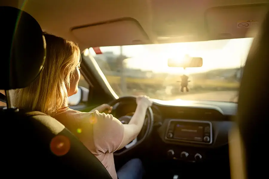 Woman behind the wheel of her car