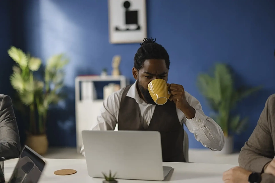 Man drinks coffee and looks for a job online