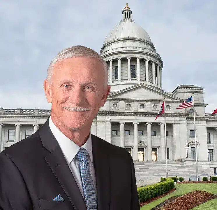 Arkansas Commissioner of State Lands, Tommy Land, in a suit in front of the Capitol of Arkansas