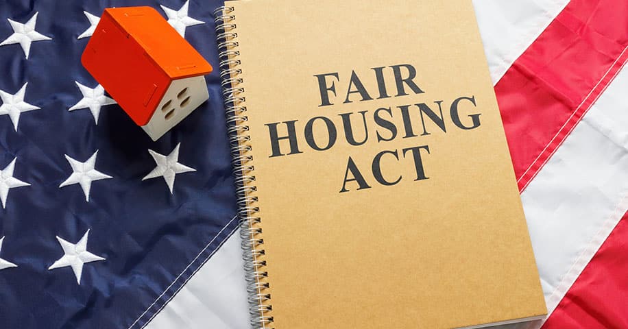 Fair housing act near tiny house on flag.