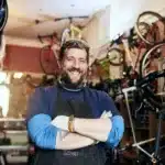 Shot of a handsome man working in his self-owned bicycle workshop