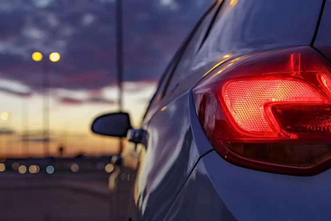 a photo of a car's brake light at dusk