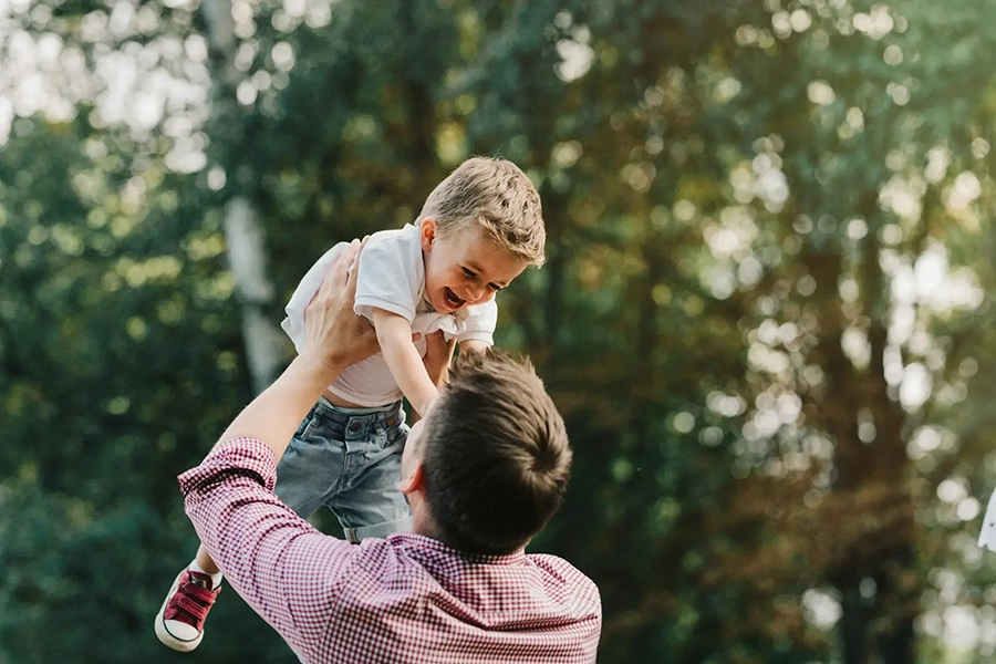 Man holding his son up in the air
